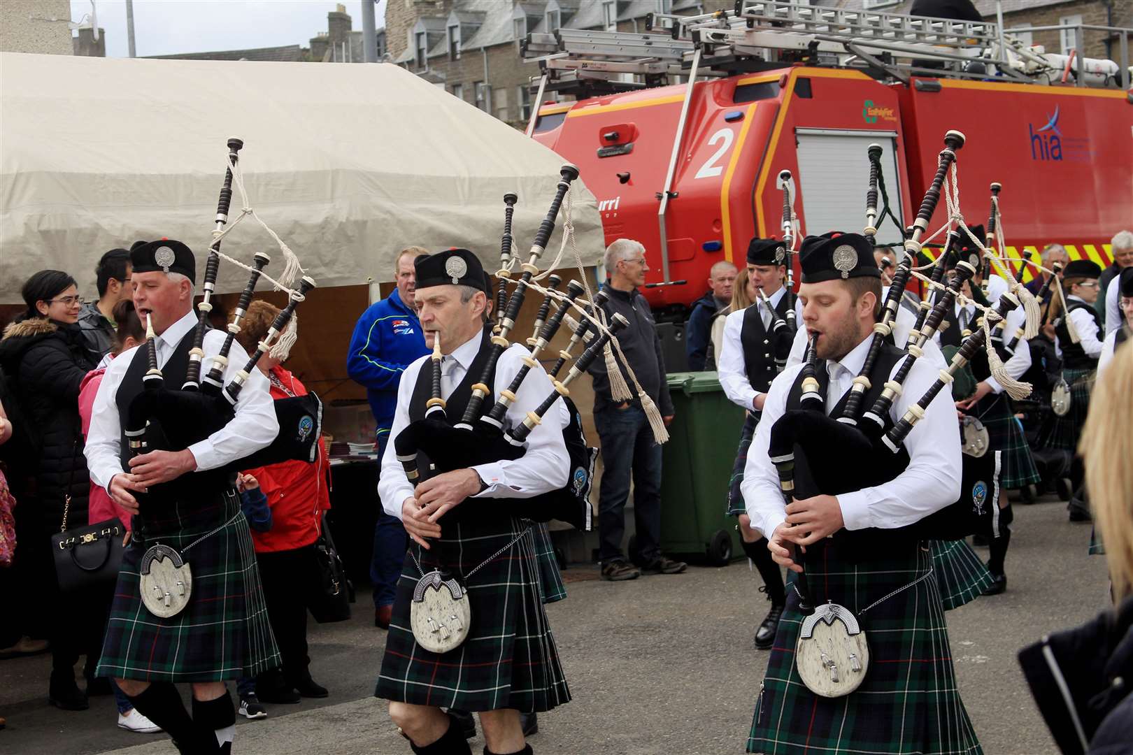 Wick RBLS Pipe Band marching along the quayside. Picture: Alan Hendry
