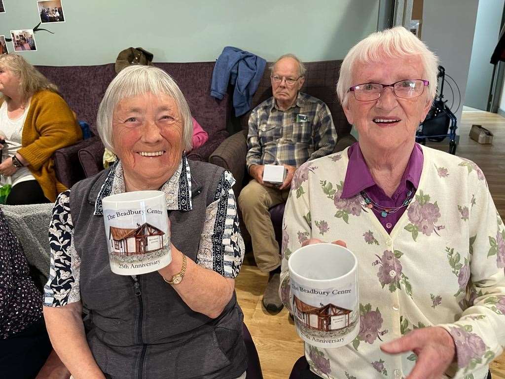 Isobel Jones, Embo, and Jenny Durrand, Dornoch, holding the commemorative mugs which were given to every client at the party.