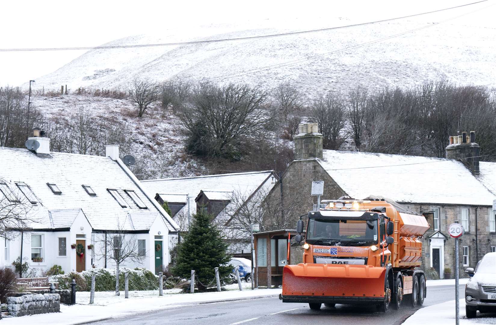 A snow plough makes its way through Carlops in the Scottish Borders (Jane Barlow/PA)