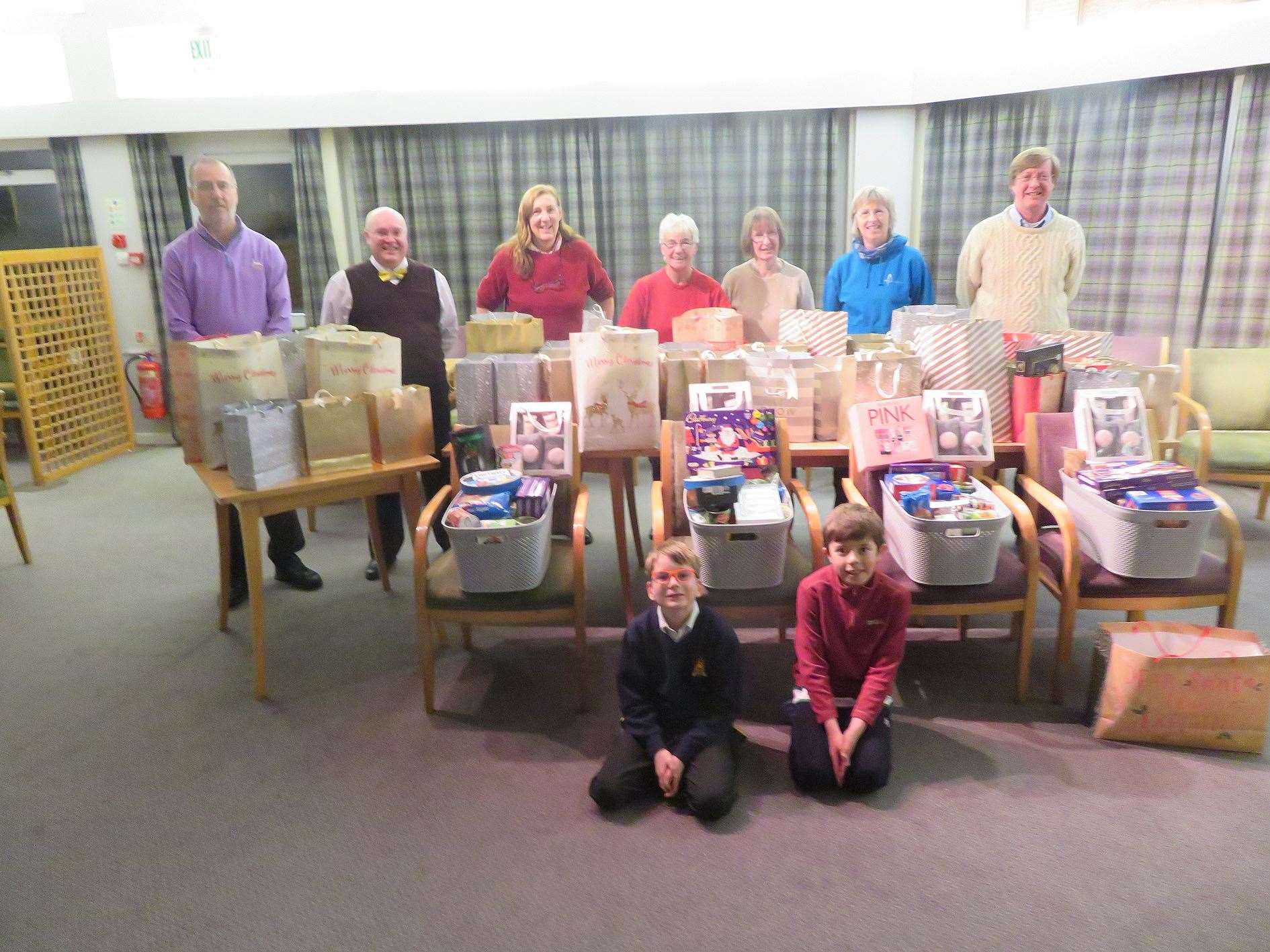 A productive evening was spent wrapping Christmas presents and filling around 70 gift bags, adults from left, Tony Gill, Simon Scott, Elizabeth Sweetman, Linda Graham, Isobel Murray, Angela Grant and John Sterrett.