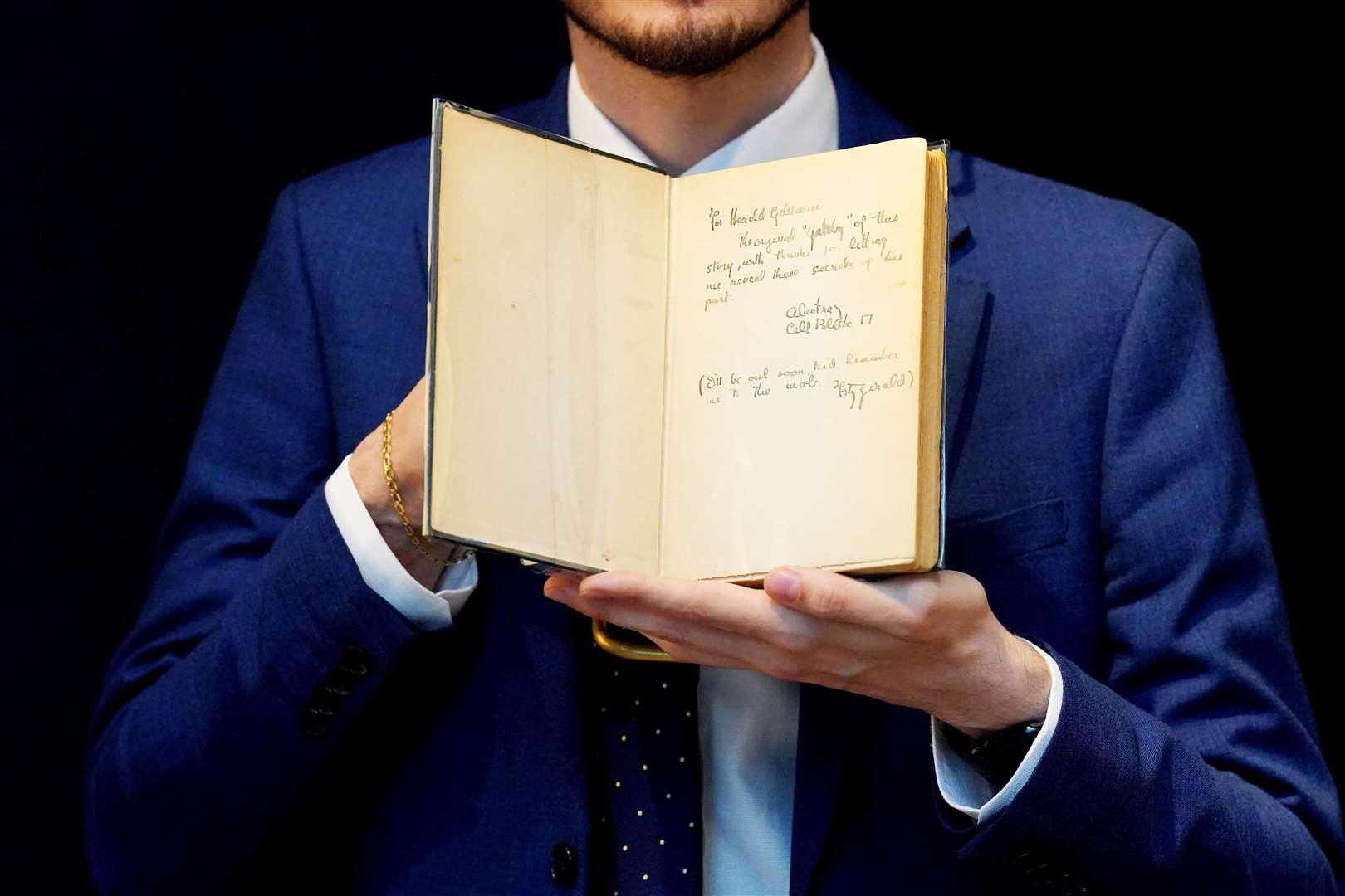Christie’s books and manuscripts specialist Mark Wiltshire holds a first edition of F. Scott Fitzgerald’s ‘The Great Gatsby’, inscribed by the author (Jonathan Brady/PA)
