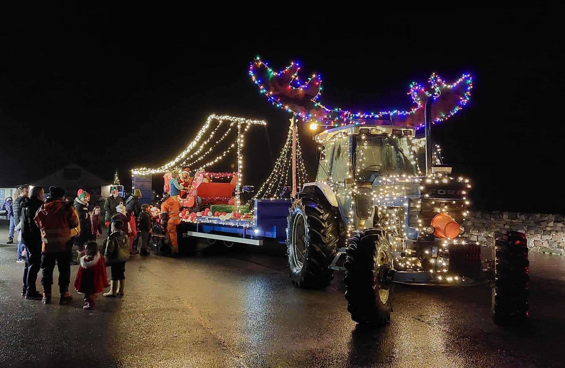 Santa and Mrs Claus were transported in a sleigh on the back of a trailer attached to a tractor decorated with huge reindeer horns. The event was a fundraiser for Scourie Primary School and Early Learning Centre.