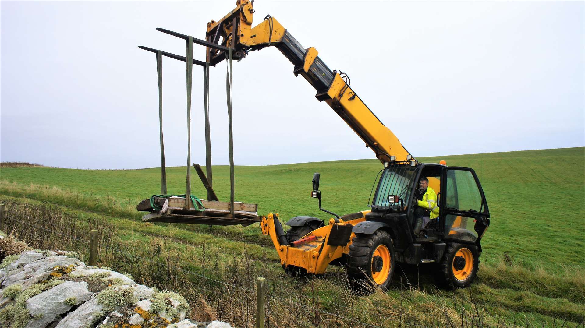 David Dunnett slowly removes the slab from the graveyard with his JCB telescopic handler. Picture: DGS