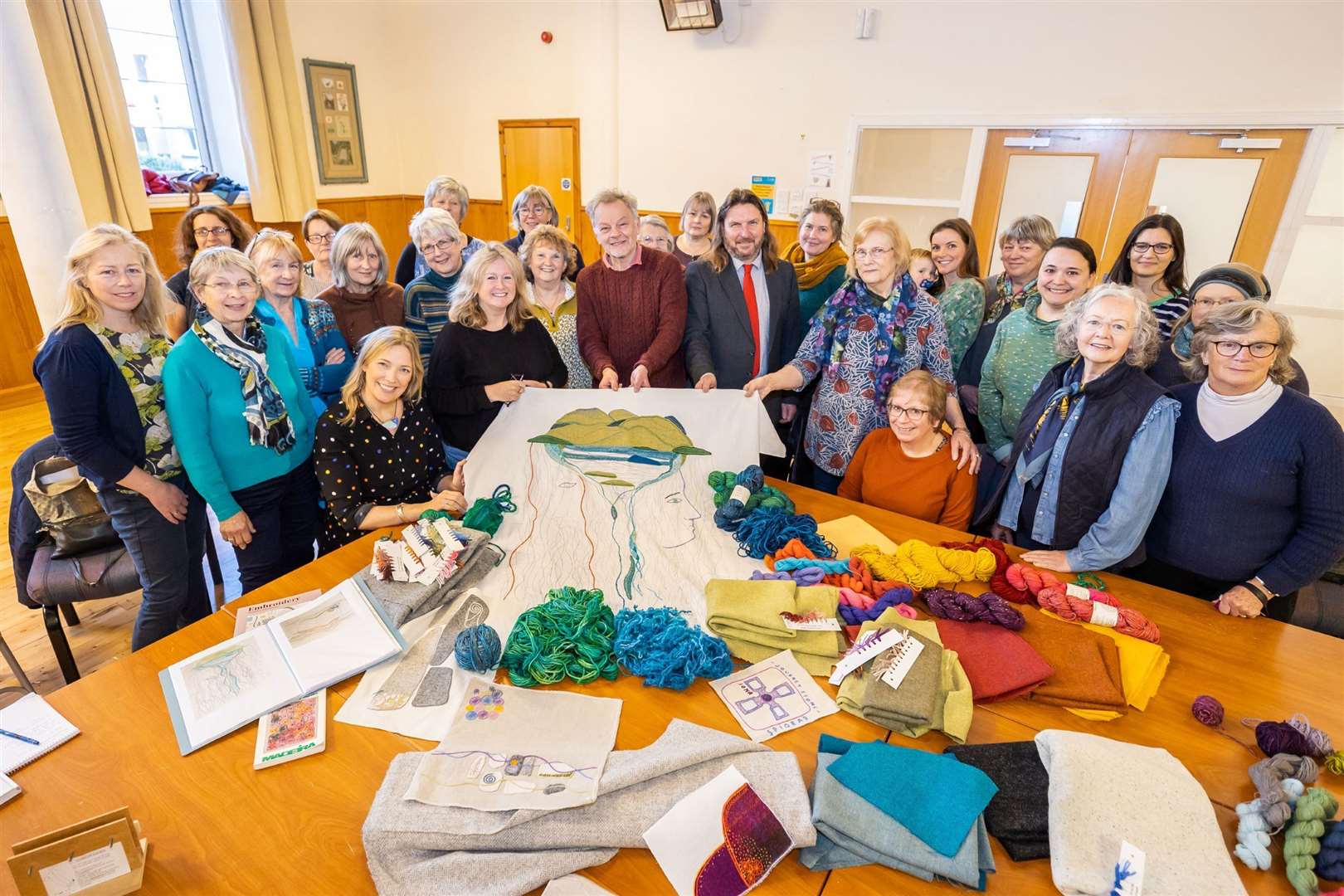 Designer Andrew Crummy, Cllr Russell Jones with Kirstie Campbell (stitch coordinator) and Spirit of the Highlands and Islands stitchers in Kingussie. Picture: HLH/Paul Campbell Photography