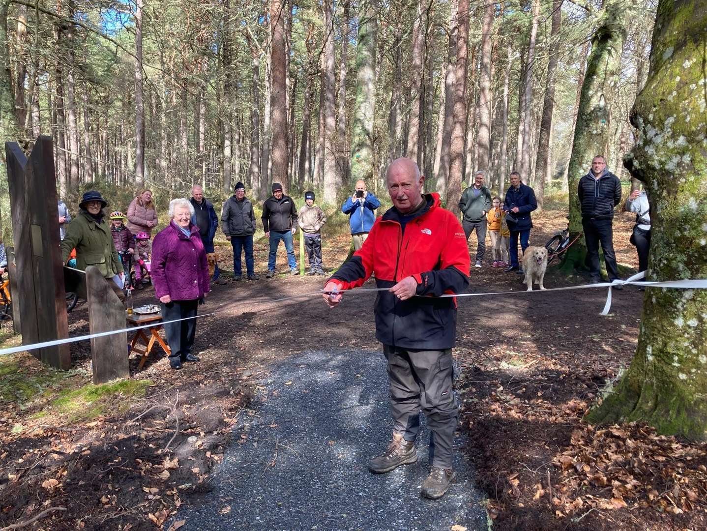 Golspie community councillor cuts a ribbon to officially open the path.