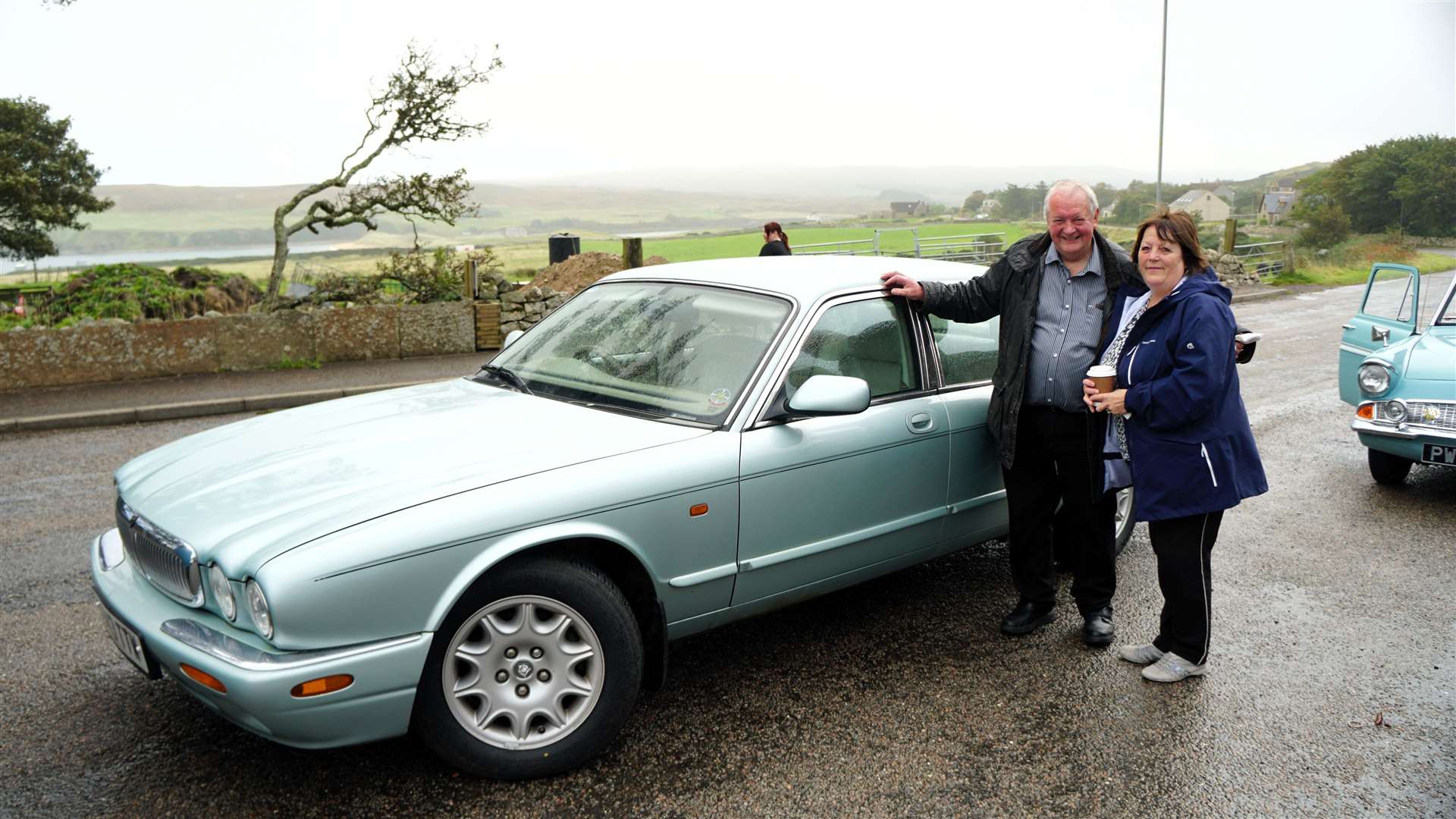 John O'Groats businessman Walter Mowat with his partner Ellen Simpson beside their 1998 Jaguar. Picture: DGS