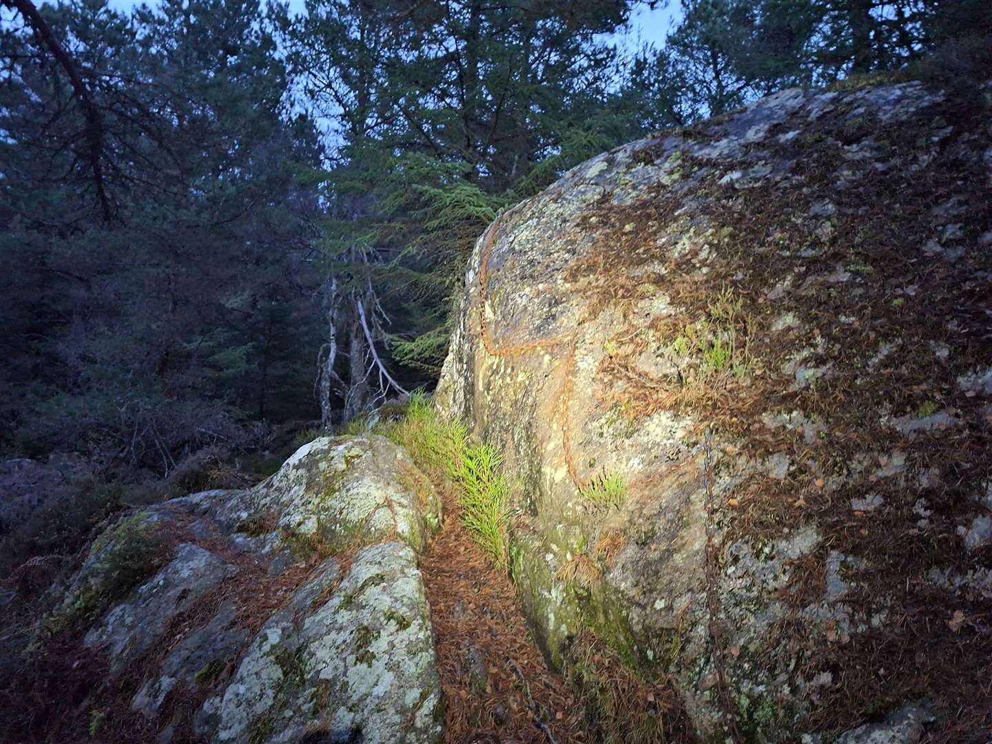 The chain rock lit up by light from the headtorch.