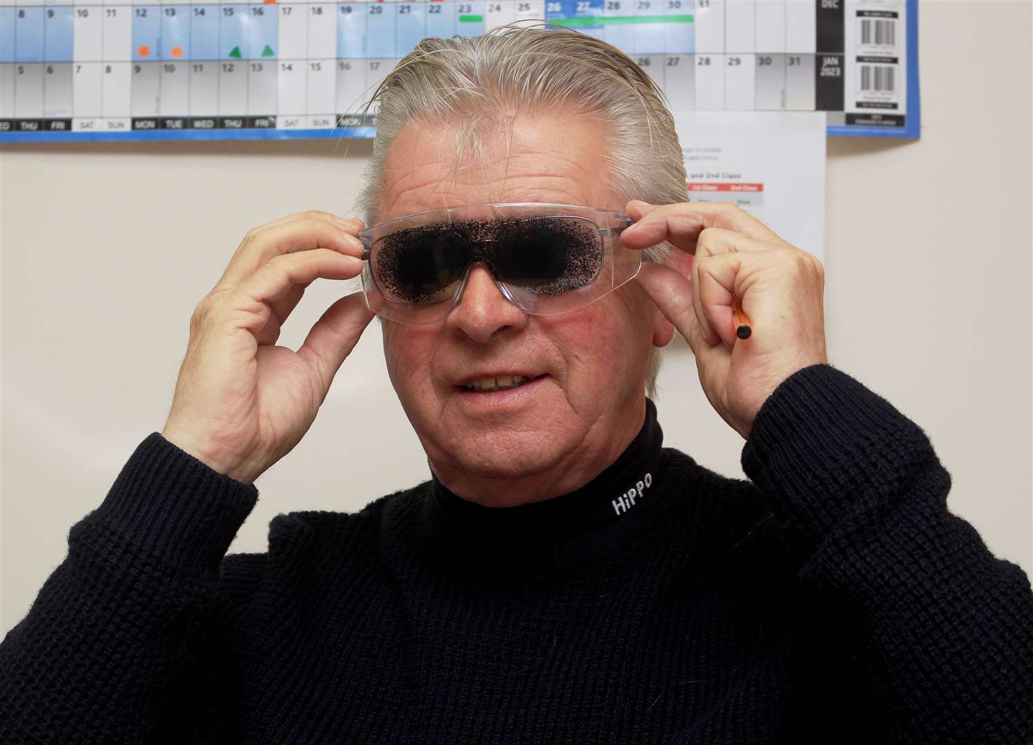 Hearing and Sight Care chairman Roy Mackenzie trying simulation specs that replicate the effects of macular degeneration.