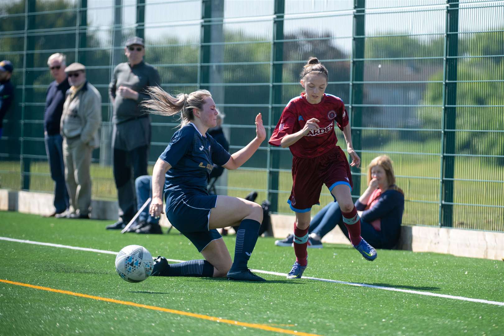 Nairn's Emma McCarthy slips a tackle from Sutherland's Erin Johnstone. Picture: Callum Mackay.