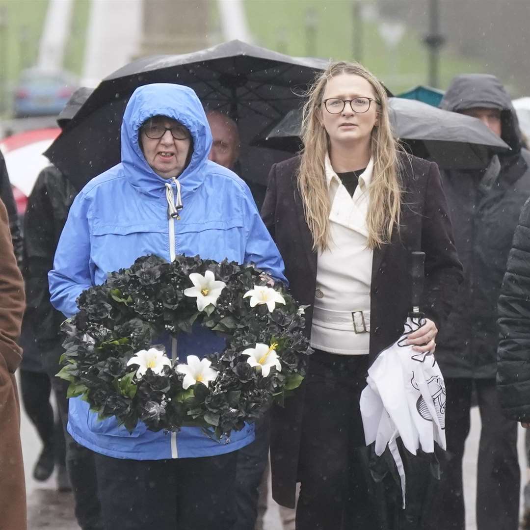 Dympna Kerr (left), sister of Columba McVeigh, carries a wreath with Irish senator Emer Currie (Niall Carson/PA)