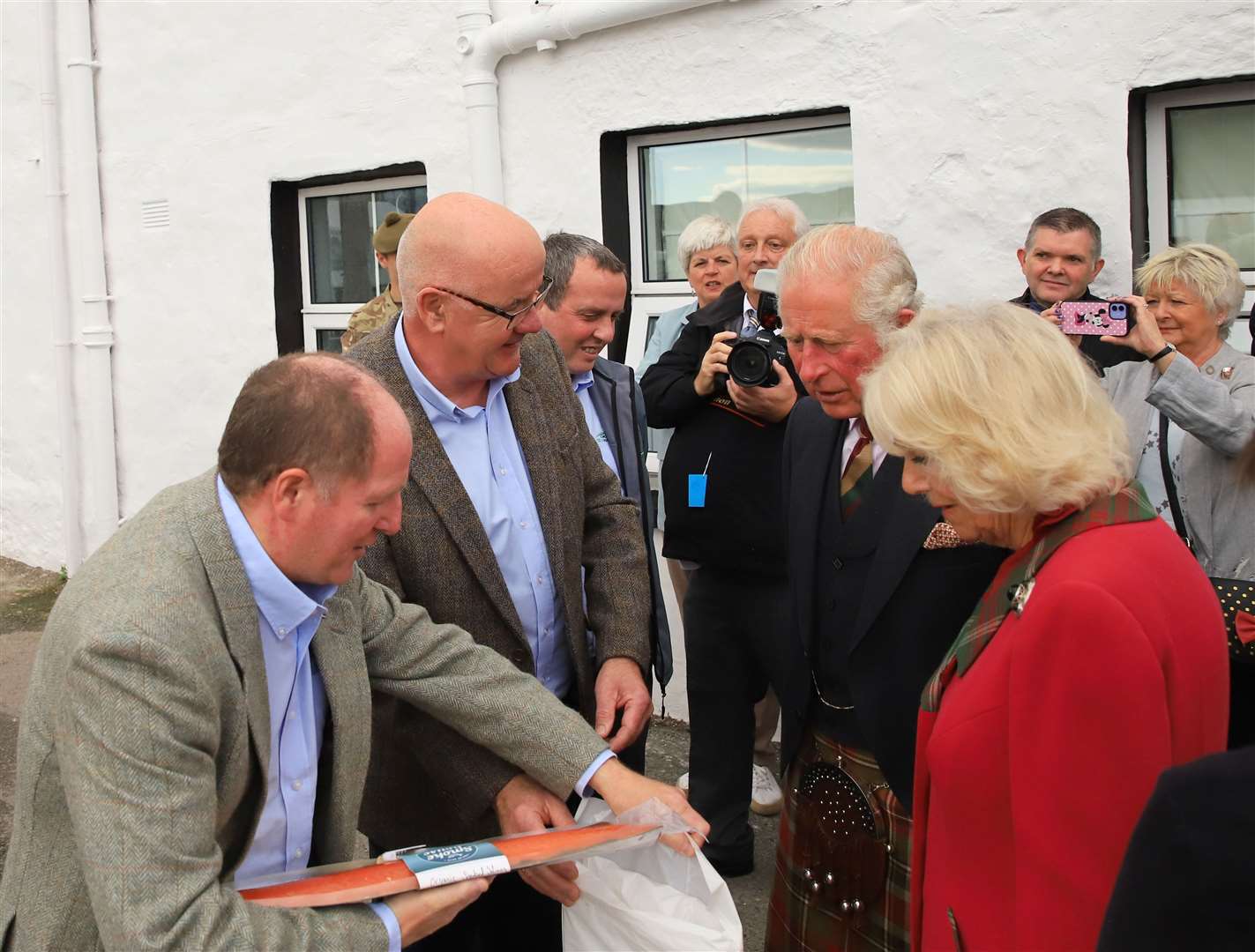 The Duke and Duchess of Rothesay are given a fish to take away.