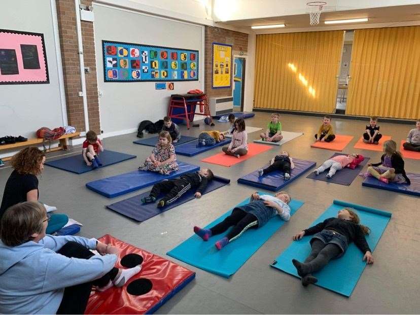 P1-3 pupils taking part in a yoga session.