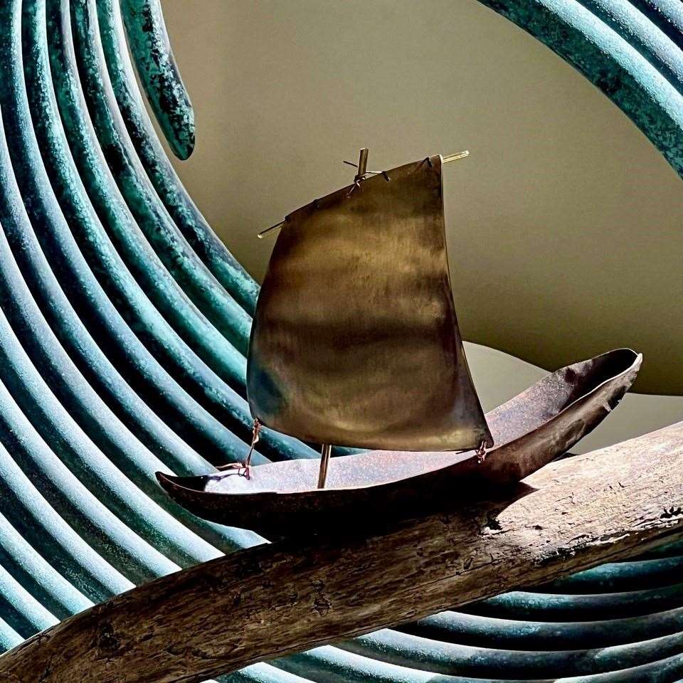 'Overwhelmed' by Barry Smith – a handmade fishing boat shaped from recycled copper and brass, driftwood and a wave form made from the patinated copper coil of a hot water system.