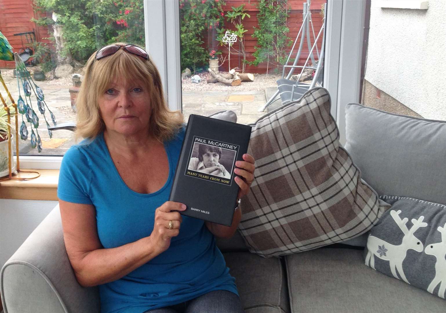 Irene Brass, of Thurso, holding a copy of the Paul McCartney biography Many Years From Now which contains a mention of the time her father, skipper George Swanson, took the McCartney family across to Orkney in the Enterprise fishing boat.