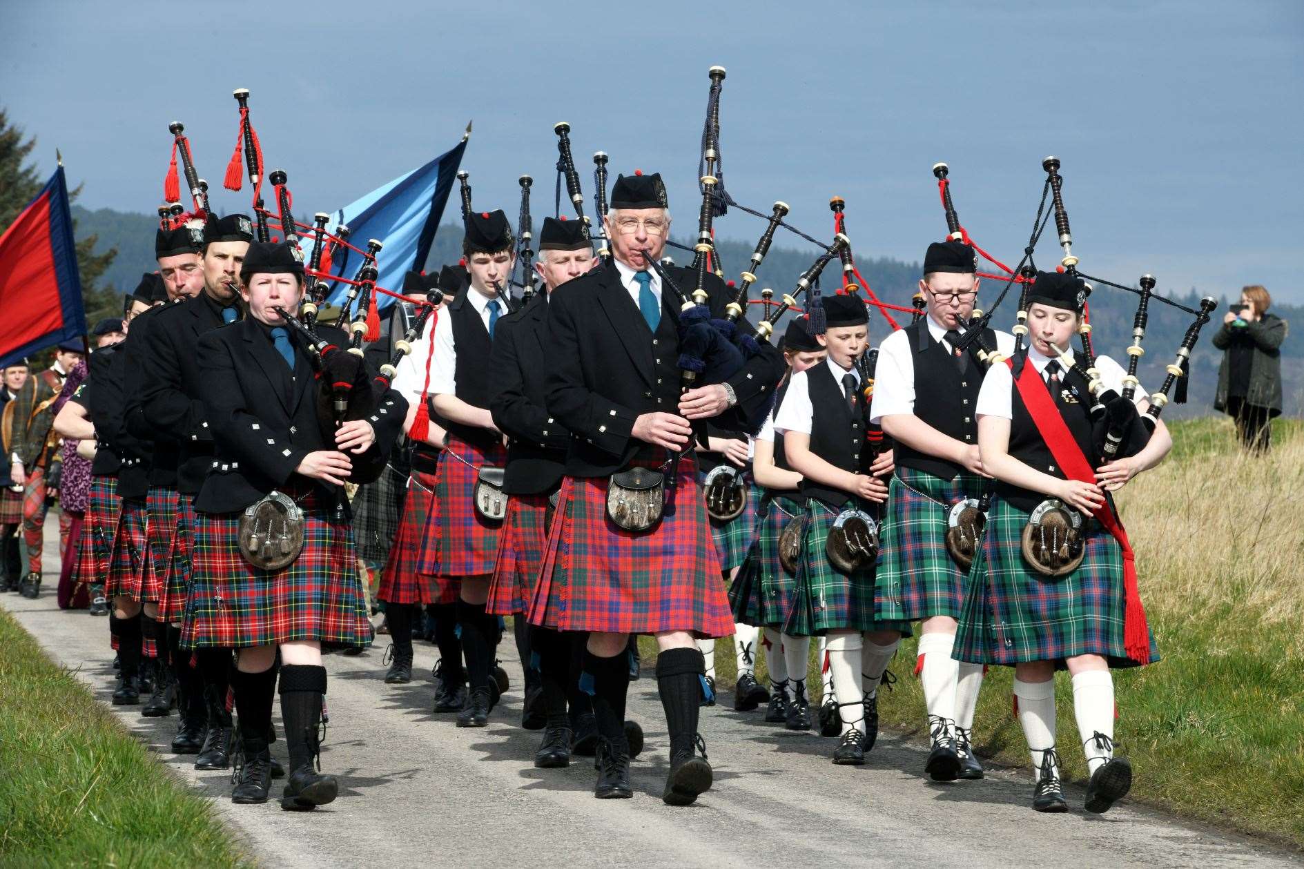Pipers from three local bands marched down a stretch of Ferry Road to the memorial. Picture: James Mackenzie.